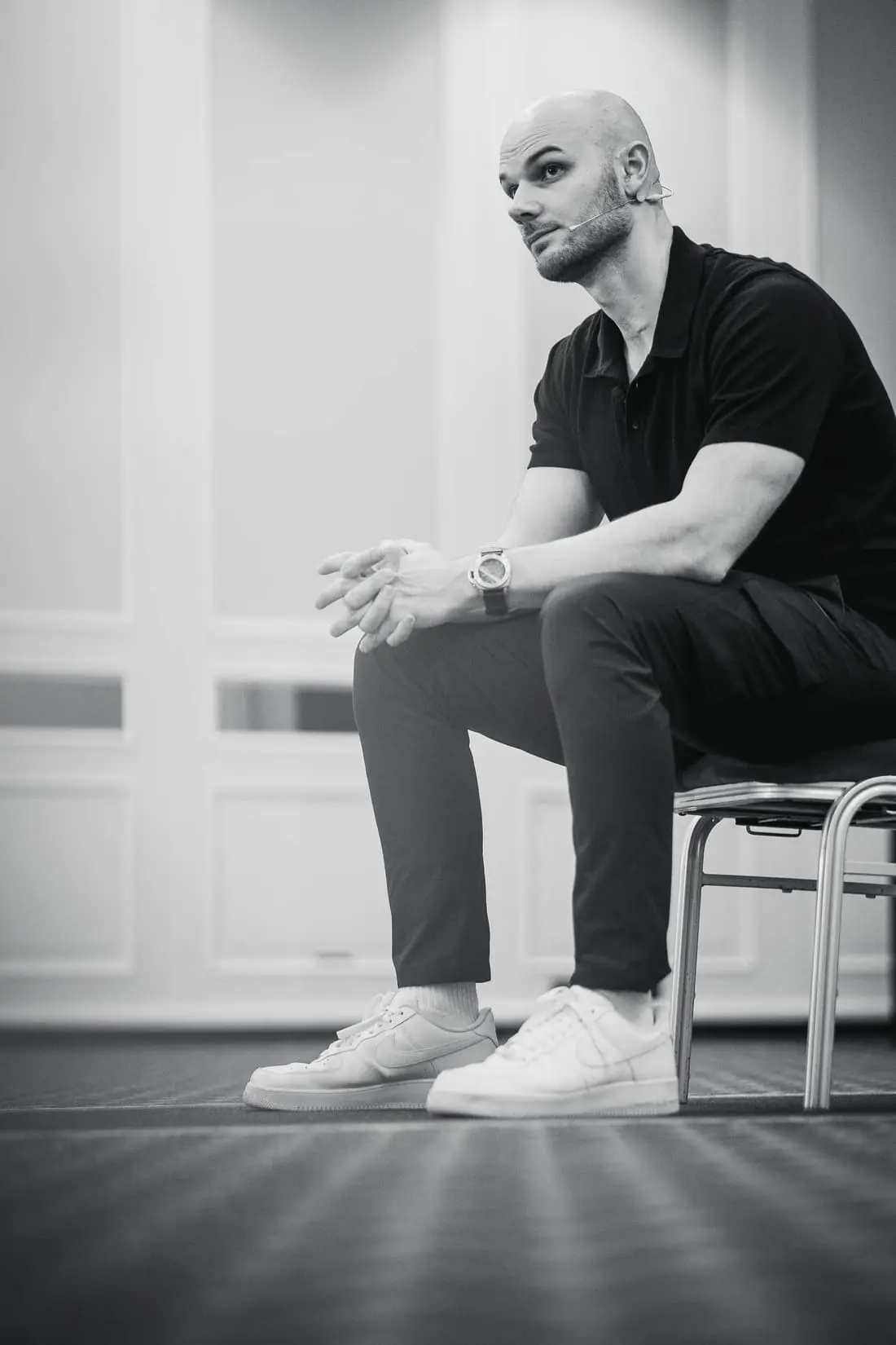 Fabian Schaub sitzt auf einem Stuhl, von der Seite, die Hände gefaltet, den Blick nach vorn